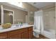Full bathroom with tub/shower combo, wood vanity with sink and large mirror and toilet at 4101 S Dewdrop Ct, Gilbert, AZ 85297