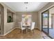 Bright dining area with a glass door leading to the patio and view of the green backyard at 4101 S Dewdrop Ct, Gilbert, AZ 85297