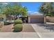 Charming home with a well-manicured front yard, desert landscaping, and a two-car garage at 4101 S Dewdrop Ct, Gilbert, AZ 85297