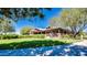 Clubhouse exterior with rustic beams, stone accents and manicured landscaping offers a welcoming gathering space at 4101 S Dewdrop Ct, Gilbert, AZ 85297