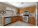 Bright kitchen with stainless steel appliances, tile flooring, and a view of the backyard at 4101 S Dewdrop Ct, Gilbert, AZ 85297