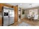 Kitchen leading to the dining area with stainless steel refrigerator and wooden cabinets at 4101 S Dewdrop Ct, Gilbert, AZ 85297
