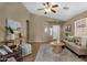 Inviting living room featuring tile floors, neutral walls, ceiling fan and an arched entryway at 4101 S Dewdrop Ct, Gilbert, AZ 85297