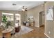 Inviting living room featuring tile floors, neutral walls, ceiling fan and view into the kitchen at 4101 S Dewdrop Ct, Gilbert, AZ 85297
