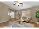 Bright living room featuring tile floors, neutral walls, ceiling fan and a view into the entryway at 4101 S Dewdrop Ct, Gilbert, AZ 85297