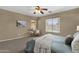 Relaxing bedroom with a cozy chair, windows, and comfortable bedding at 4101 S Dewdrop Ct, Gilbert, AZ 85297