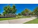 Community entrance sign for Ranch House Clubhouse & Park, featuring beautiful landscaping and mature trees along the walkway at 4101 S Dewdrop Ct, Gilbert, AZ 85297