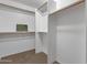 This walk-in closet provides ample storage space with multiple shelves and racks for organization at 4101 S Dewdrop Ct, Gilbert, AZ 85297