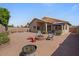 Cozy backyard area with patio, desert landscaping, and fire pit perfect for entertaining at 4459 E Desert Wind Dr, Phoenix, AZ 85044