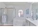 Bright bathroom features a soaking tub, glass shower, and a large vanity offering a spa-like experience at 4459 E Desert Wind Dr, Phoenix, AZ 85044