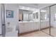 Bathroom with double vanity, large mirror, and tiled floors at 4459 E Desert Wind Dr, Phoenix, AZ 85044