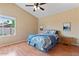 Cozy bedroom with wood-look floors, and a large window at 4459 E Desert Wind Dr, Phoenix, AZ 85044