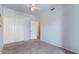 Bedroom featuring neutral carpet, a ceiling fan and a double closet at 4459 E Desert Wind Dr, Phoenix, AZ 85044