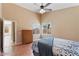 Bedroom featuring a ceiling fan, wood floors, and a bright window view at 4459 E Desert Wind Dr, Phoenix, AZ 85044
