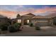 Charming single-story home with a tile roof, mature landscaping, and a welcoming front entrance at 4459 E Desert Wind Dr, Phoenix, AZ 85044