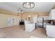 Open concept kitchen with white cabinets, stainless steel appliances, and island overlooking the living area at 4459 E Desert Wind Dr, Phoenix, AZ 85044