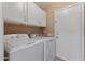 Functional laundry room with washer, dryer and ample storage at 4459 E Desert Wind Dr, Phoenix, AZ 85044