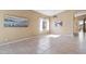 Well-lit living room with tile floors, large window, and adjacent hallway at 4459 E Desert Wind Dr, Phoenix, AZ 85044