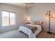 Bright bedroom featuring a ceiling fan, a window with natural light and a unique modern lamp at 509 W Villa Rita Dr, Phoenix, AZ 85023
