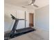 Carpeted bedroom with ceiling fan, closet, and treadmill for exercise and recreation at 509 W Villa Rita Dr, Phoenix, AZ 85023