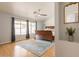 Bedroom features wood floors, windows for natural light, and a ceiling fan at 509 W Villa Rita Dr, Phoenix, AZ 85023