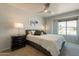 Bedroom featuring picture window, ceiling fan, and modern furnishings at 509 W Villa Rita Dr, Phoenix, AZ 85023