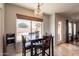 Breakfast nook features a square table set, backyard view, and updated lighting at 509 W Villa Rita Dr, Phoenix, AZ 85023