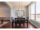 Dining room features wood floors, a dining set, decorative mirrors, and backyard views at 509 W Villa Rita Dr, Phoenix, AZ 85023