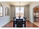 Traditional dining room with wood floors, a dining set, modern lighting, and natural light at 509 W Villa Rita Dr, Phoenix, AZ 85023