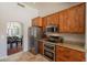 Modern kitchen featuring stainless steel appliances, granite countertops, and a view into the dining space at 509 W Villa Rita Dr, Phoenix, AZ 85023