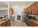 Spacious kitchen features granite countertops, stainless steel appliances, and connects to the dining area at 509 W Villa Rita Dr, Phoenix, AZ 85023