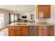 Well-lit kitchen with a granite countertop island, stainless steel appliances, and open access to the living area at 509 W Villa Rita Dr, Phoenix, AZ 85023
