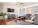 Comfortable living room featuring hardwood floors, a plush sectional, and stylish decor at 509 W Villa Rita Dr, Phoenix, AZ 85023