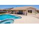 Backyard oasis featuring a sparkling pool and a covered patio seating area at 509 W Villa Rita Dr, Phoenix, AZ 85023