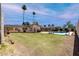 Expansive backyard featuring a lush lawn, pool area, mature trees, and a covered patio for outdoor enjoyment at 533 E 7Th Pl, Mesa, AZ 85203