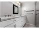 Bathroom featuring double vanity, modern fixtures, mirror, and shower with glass at 533 E 7Th Pl, Mesa, AZ 85203