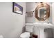 Powder room featuring a pedestal sink, decorative mirror and paint color at 533 E 7Th Pl, Mesa, AZ 85203