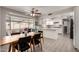 Bright dining area featuring a large wooden table with seating and an adjacent kitchen at 533 E 7Th Pl, Mesa, AZ 85203