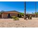 Single-story brick home with desert landscaping, arched windows, and tall palm trees under a clear sky at 533 E 7Th Pl, Mesa, AZ 85203