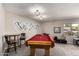 Bright game room with a pool table, bar seating, and a view of the neighborhood at 533 E 7Th Pl, Mesa, AZ 85203