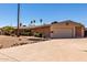 Single-story home with desert landscaping, a two-car garage, and a long driveway under a clear sky at 533 E 7Th Pl, Mesa, AZ 85203
