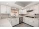 Bright kitchen with sleek white cabinetry, modern appliances, and a view to the outdoor patio at 533 E 7Th Pl, Mesa, AZ 85203
