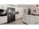 Modern kitchen with stainless steel appliances, white cabinets, and a convenient kitchen island at 533 E 7Th Pl, Mesa, AZ 85203