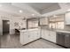 Well-lit kitchen with white cabinetry, stainless steel appliances, and an adjacent dining area at 533 E 7Th Pl, Mesa, AZ 85203