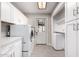 Well-organized laundry room with modern appliances, ample cabinet space, and a convenient layout for chores at 533 E 7Th Pl, Mesa, AZ 85203