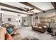 Spacious living room with exposed beams, multiple sofas, and an adjacent sunroom at 533 E 7Th Pl, Mesa, AZ 85203