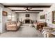 Charming living room with exposed beams, brick fireplace, and comfortable seating at 533 E 7Th Pl, Mesa, AZ 85203