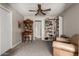Comfortable living room with a ceiling fan, built-in bookshelves, and ample space for relaxation and entertainment at 533 E 7Th Pl, Mesa, AZ 85203
