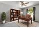 Office featuring a large desk, shelving unit, and natural light at 533 E 7Th Pl, Mesa, AZ 85203