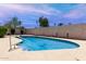 Inviting backyard pool features cool blue water, a white deck, and well-maintained perimeter landscaping at 533 E 7Th Pl, Mesa, AZ 85203